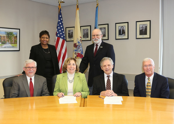 Seated, from left: Dr. Mark McCormick, vice president for academic and student affairs, and Dr. Joann La Perla-Morales, president at Middlesex County College; David E. Schroeder, president, and Wayne R. Dyer, vice president of strategic alliances, at Pillar College. Standing: Marla Brinson, dean of student affairs, and Patrick Madama, vice president for institutional advancement, at Middlesex.